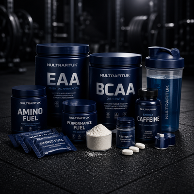 NULTRAFITUK performance and endurance supplements including EAA, BCAA, amino fuel mix, caffeine capsules and endurance nutrition products arranged on a rubber gym floor in a dark gym environment.