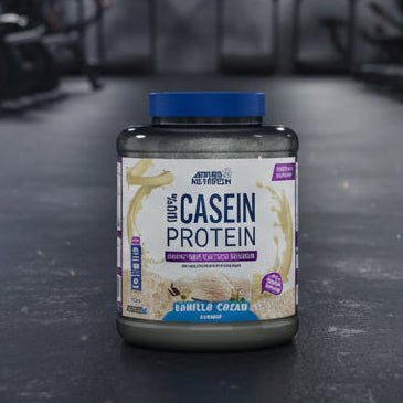 Applied Nutrition 100% Casein Protein container with vanilla cream flavour on a gym background