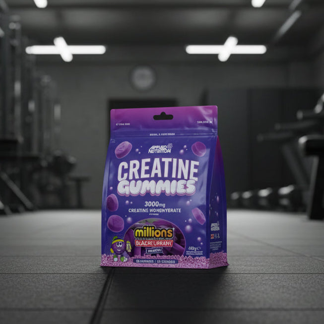 Purple package of Applied Nutrition Creatine Gummies with blackcurrant flavour on a gym background