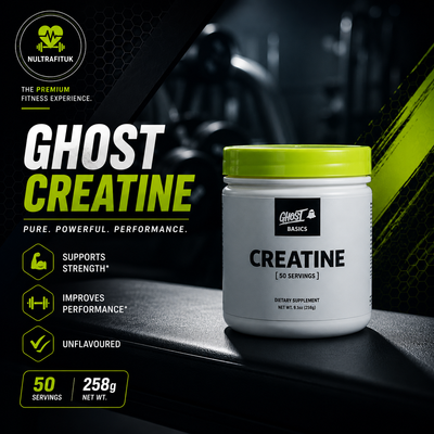 A white tub of Ghost Basics Creatine with a bright lime green lid, displayed on a dark gym bench. The background is a dark, moody gym setting with black and grey tones, accented by bold text and icons highlighting product benefits.