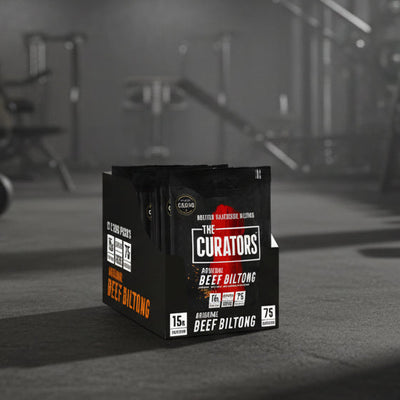 Box of 'The Curators' beef biltong in a gym setting