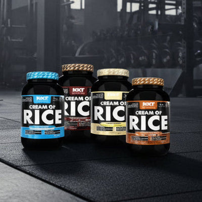 Four bottles of Cream of Rice on a gym floor with gym equipment in the background