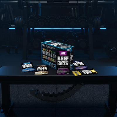 NXT Nutrition beef protein isolate packaging on a dark textured background