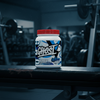 Ghost whey protein powder container on a gym floor background