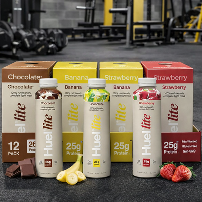 HUEL Lite Ready-to Drink Mixed flavours on a gym floor.