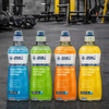 Four bottles of Applied Nutrition BodyFuel electrolyte and vitamin water in different flavors on a gym floor.