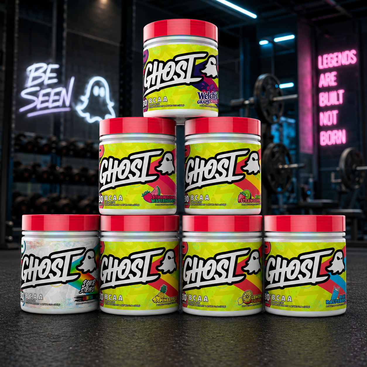 Stack of Ghost nutrition supplement containers in a gym setting with neon signs.