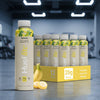 HUEL Lite Ready-to Drink banana flavour case on a gym floor.
