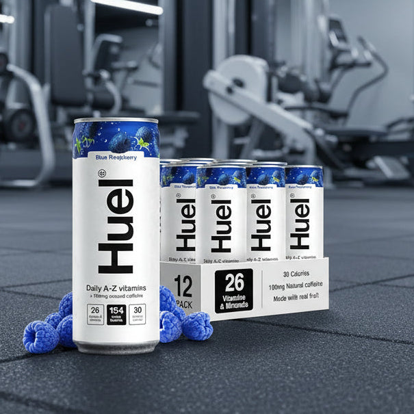 HUEL Daily A-Z Vitamin blue raspberry 
flavour Cans on a gym floor