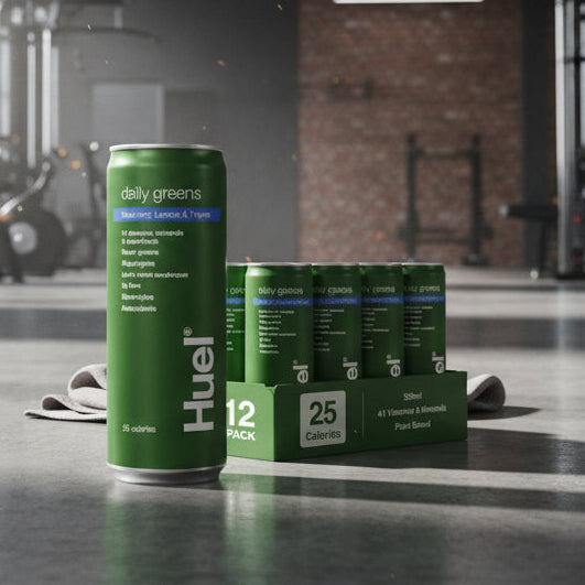 Huel Daily Greens Cans Blueberry, Lemon & Thyme Flavour on a gym floor.