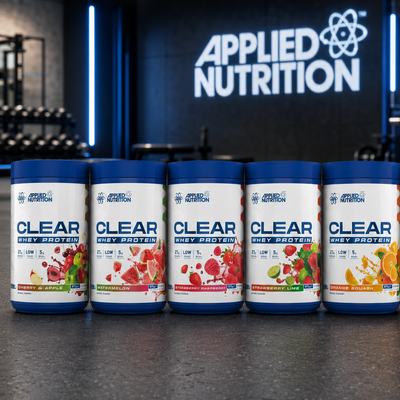 Row of Applied Nutrition protein powder containers in a gym setting