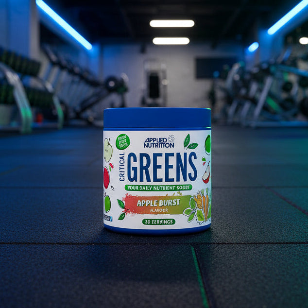 Applied Nutrition Critical Greens container with apple burst flavour on a gym background