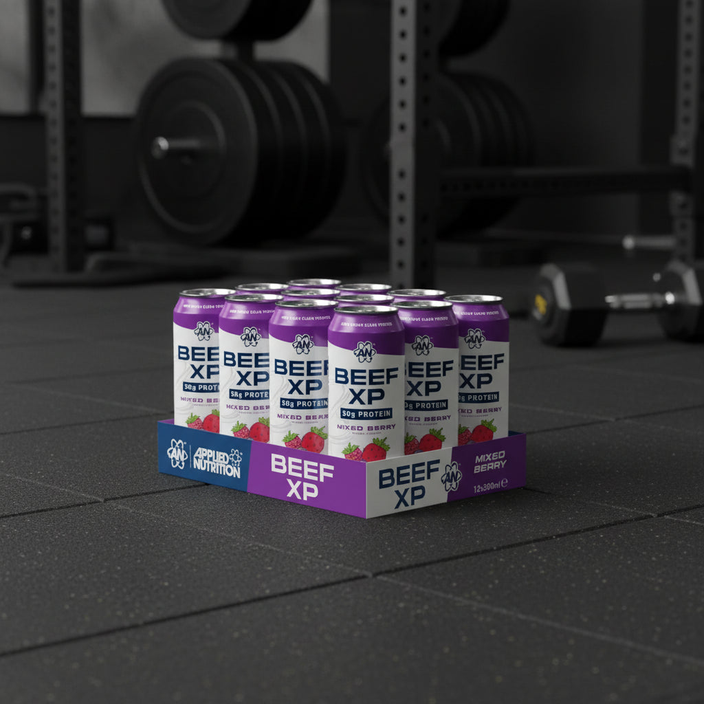 Beef XP protein cans and packaging on a gym floor with weights in the background