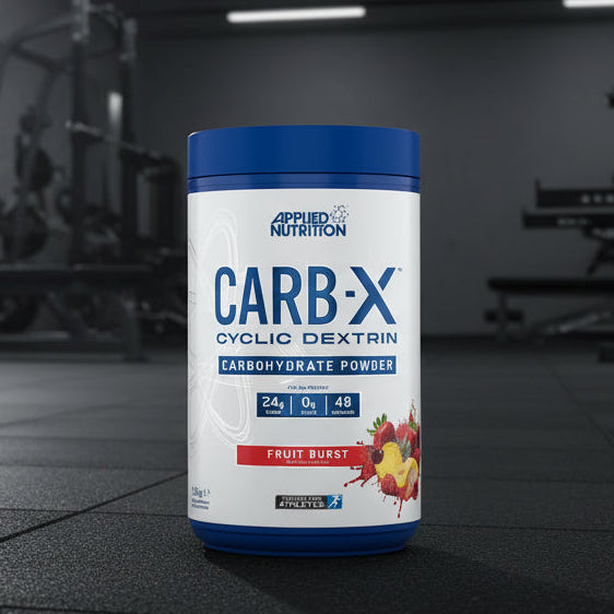 Applied Nutrition Carb-X Cyclic Dextrin powder container on a gym floor