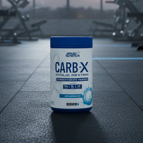 Applied Nutrition Carb-X Cyclic Dextrin powder container on a gym floor