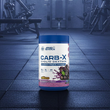 Applied Nutrition Carb-X Cyclic Dextrin powder container on a gym floor