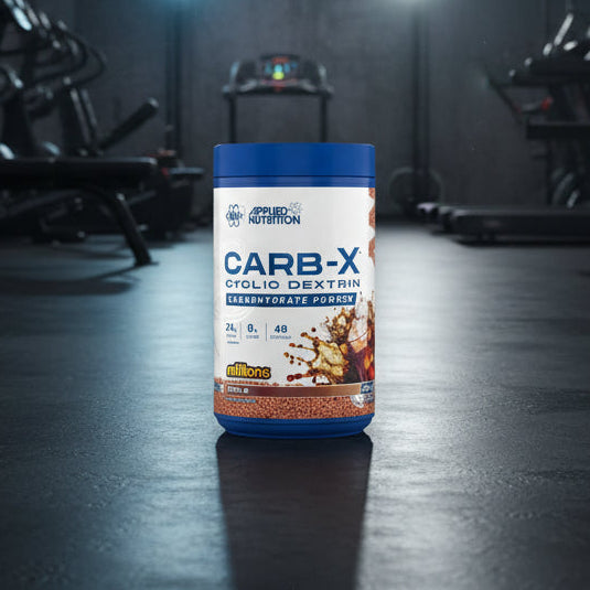 Applied Nutrition Carb-X Cyclic Dextrin powder container on a gym floor