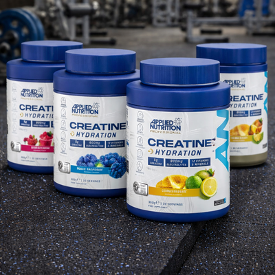 Applied Nutrition Creatine + Hydration Tubs on a gym floor