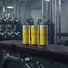 Four cans of Red Bull Summer Edition Citrus Zest energy drink on a gym background