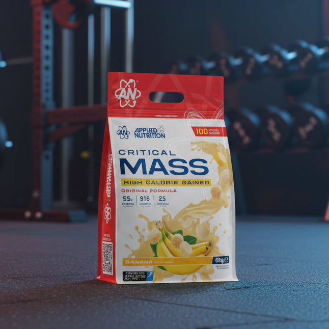 Applied Nutrition Critical Mass High Calorie Gainer package on a gym background