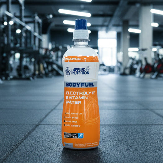 Bottle of Applied Nutrition BodyFuel Electrolyte and Vitamin Water on a gym background
