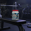 A white plastic tub of Ghost Whey Clear Protein Isolate in Blue Raspberry flavor, featuring a bright red lid and a colorful label with a ghost logo.