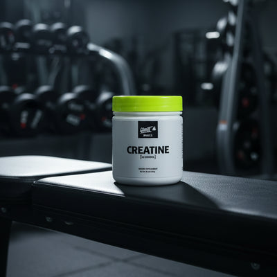 Ghost Basics Creatine supplement container with yellow lid on a gym background