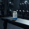 Myvitamins Alpha Men supplement bottle on a gym background