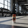 Tenzing natural energy drink can on a gym background