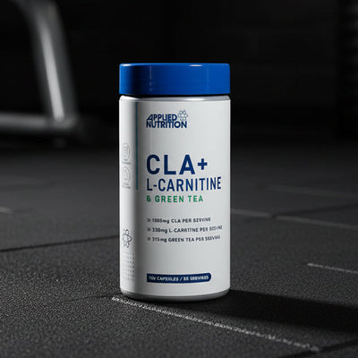 Supplement container labelled 'CLA+ L-Carnitine & Green Tea' by Applied Nutrition on a gym background