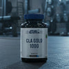 Two bottles of Applied Nutrition CLA Gold 1000 on a gym background