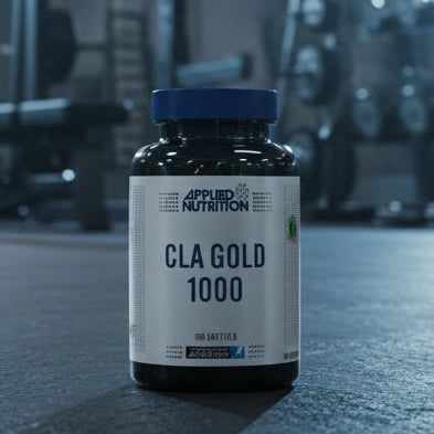 Two bottles of Applied Nutrition CLA Gold 1000 on a gym background