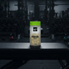 Ghost Basics Fish Oil supplement container on a gym background