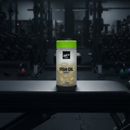 Ghost Basics Fish Oil supplement container on a gym background