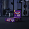 Box of Snickers Hi Protein Low Sugar bars on a gym background