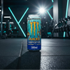 Monster energy drink can with colourful design on a gym background