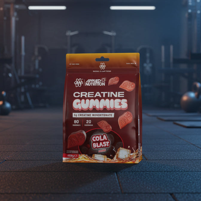 Package of Applied Nutrition Creatine Gummies with cola blast flavour on a gym background
