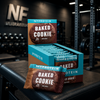 MyProtein Baked Cookie protein bars in a box on a gym bench.