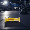 Grenade bar on a gym floor with equipment in the background