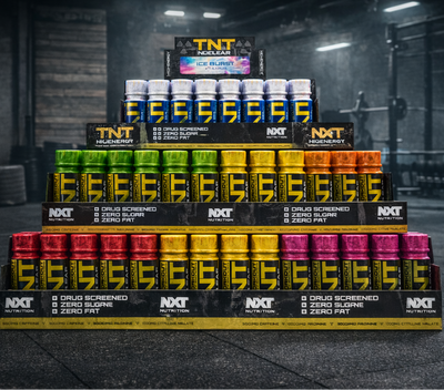 Stack of supplement bottles with visible branding in a gym setting