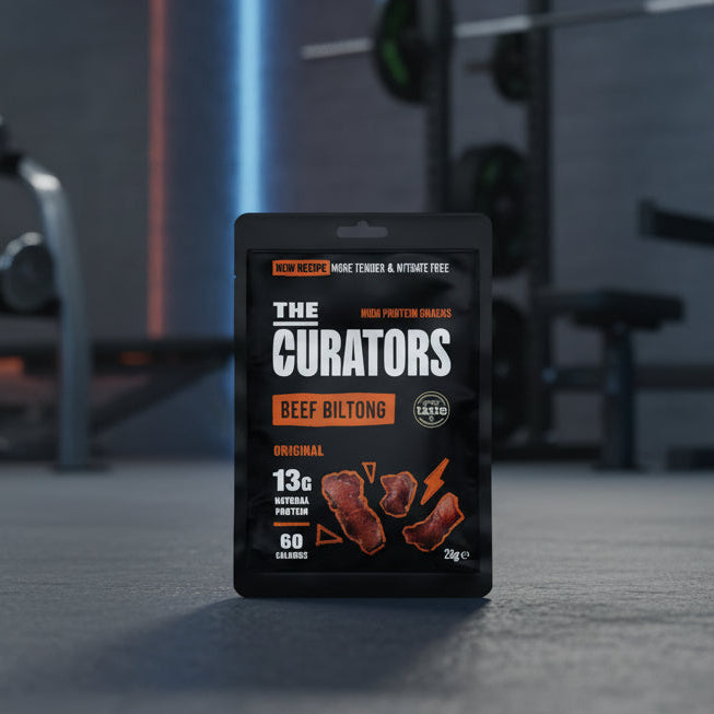 Packaged beef biltong with 'The Curators' branding in a gym setting