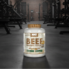 Beef protein isolate container with 'NXT Nutrition' branding in a gym setting