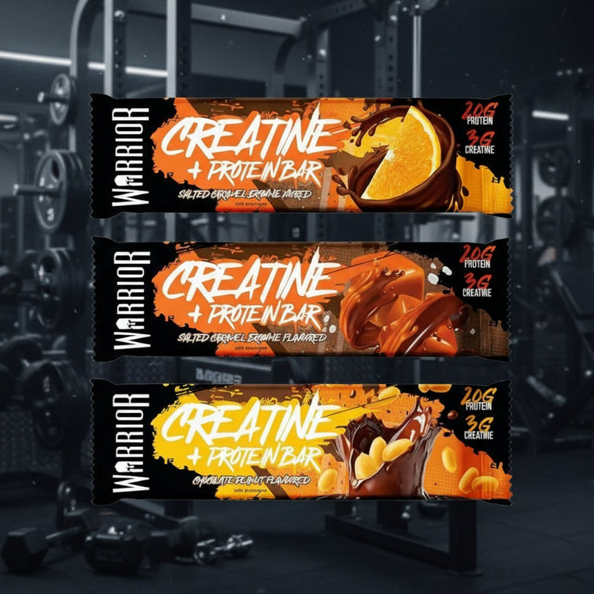 Three Warrior Creatine + Protein Bars on a stand with a gym background