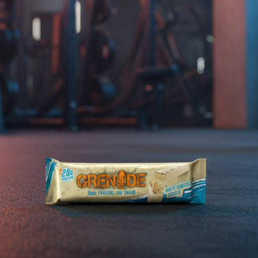 Grenade protein bar on a gym floor with equipment in the background
