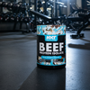 Beef protein isolate container with NXT Nutrition branding in a gym setting