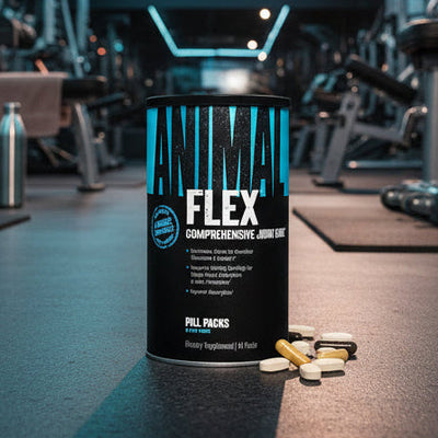 Black supplement canister labeled 'Animal Flex' with various pill packs on a gym background