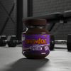 Jar of Grenade protein spread on a gym floor with weights in the background