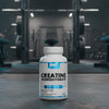 Creatine monohydrate supplement bottle in a gym setting
