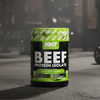 Beef protein isolate container with gym equipment in the background