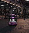 Beef Mass Gain supplement container with NXT Nutrition branding on a gym background
